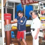 Receiving corrections on the wooden dummy (Mook Yan Chong)