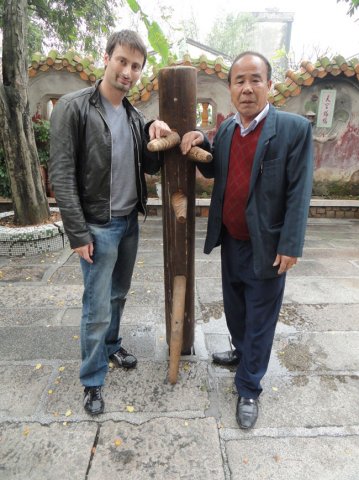 sifu Sergio with sifu Tam Woon Biu with sifu Chan Yiu Ming's original wooden dummy the late GM Ip Man got taught on this dummy